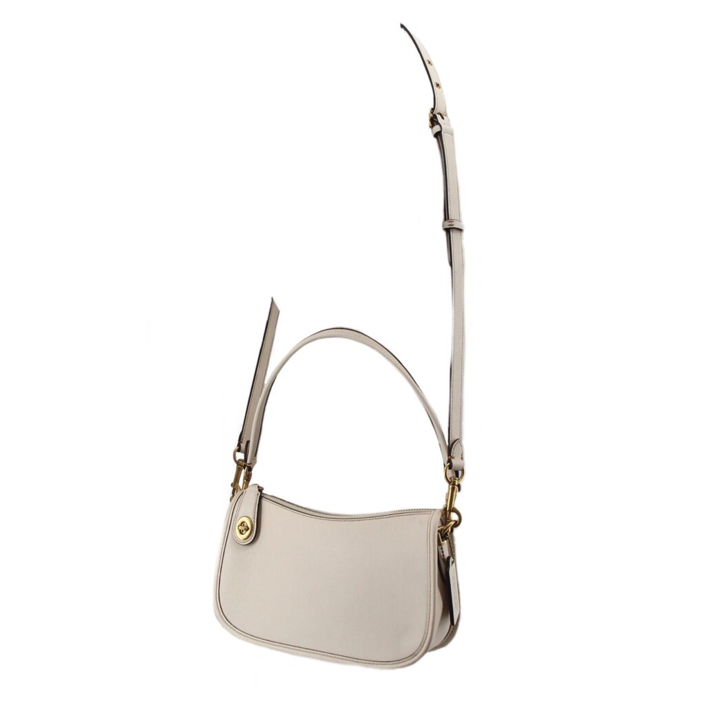 Cream COACH Swinger bag with its long adjustable crossbody strap extended