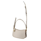 Cream COACH Swinger bag with its long adjustable crossbody strap extended