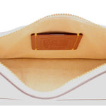 Interior of the COACH Swinger bag with fabric lining and a leather brand patch
