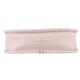Bottom of the cream COACH Swinger leather bag with a centered leather stamp