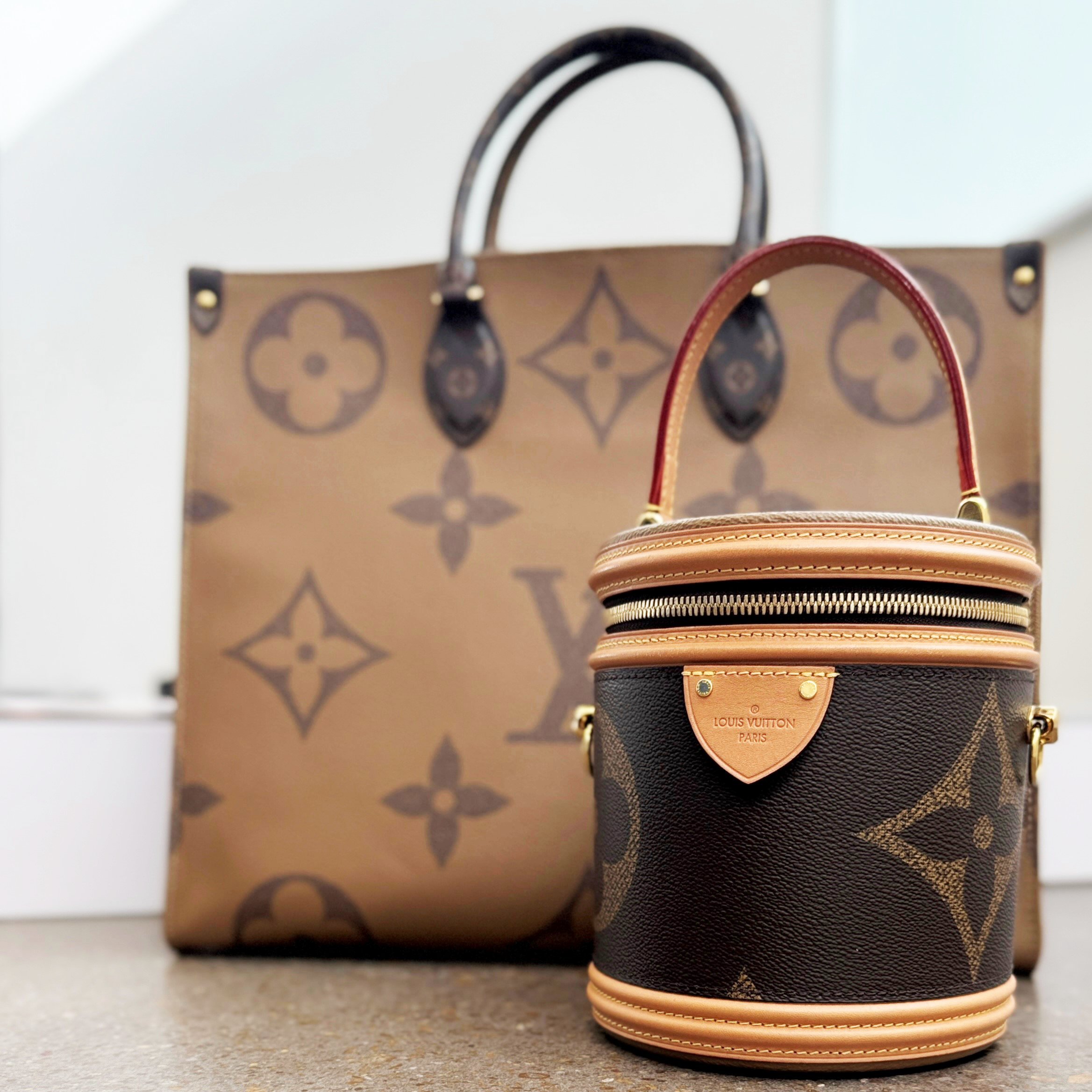 Two Louis Vuitton handbags with the Giant Monogram coated canvas.