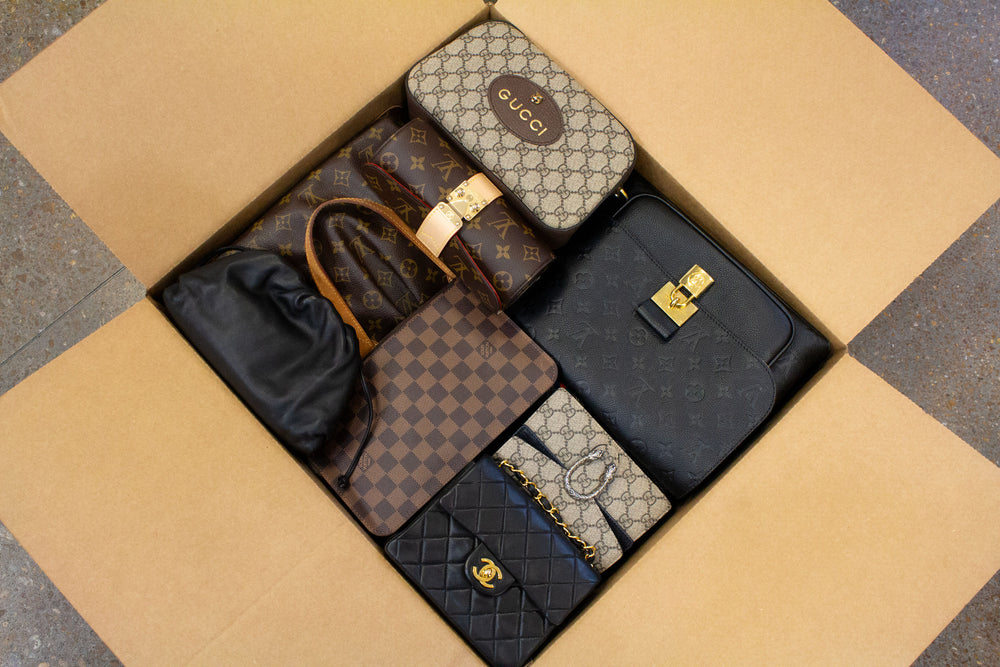 A photo of luxury designer bags in a large shipping box.