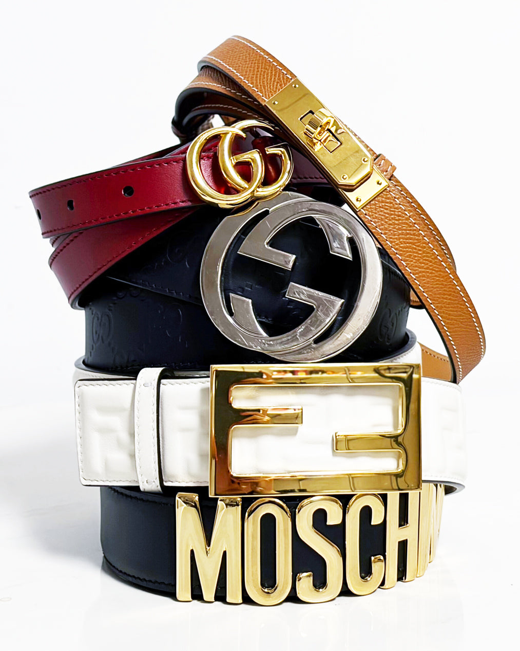 A stack of designer belts on a white background.