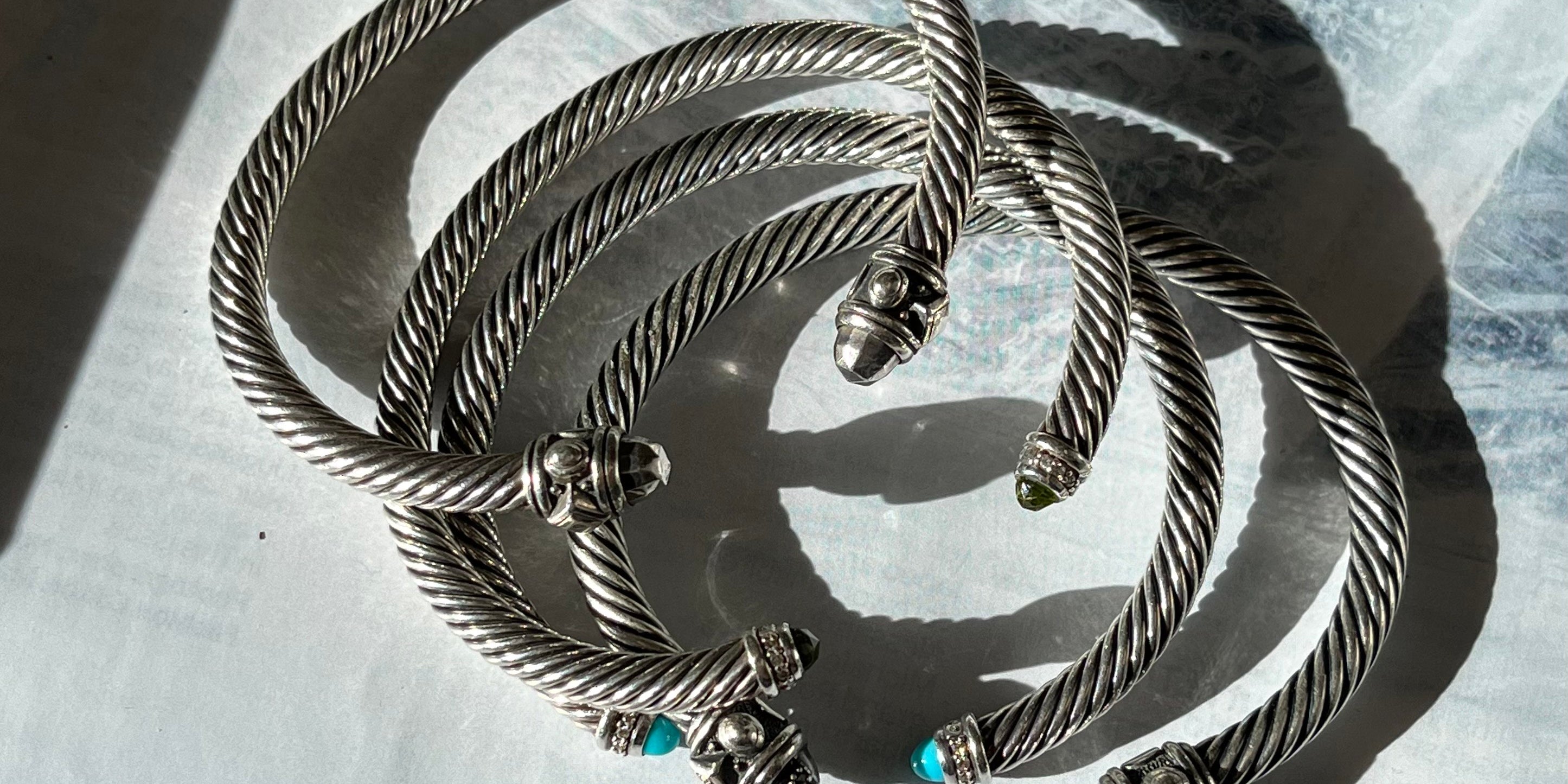 Stacked David Yurman bracelets.