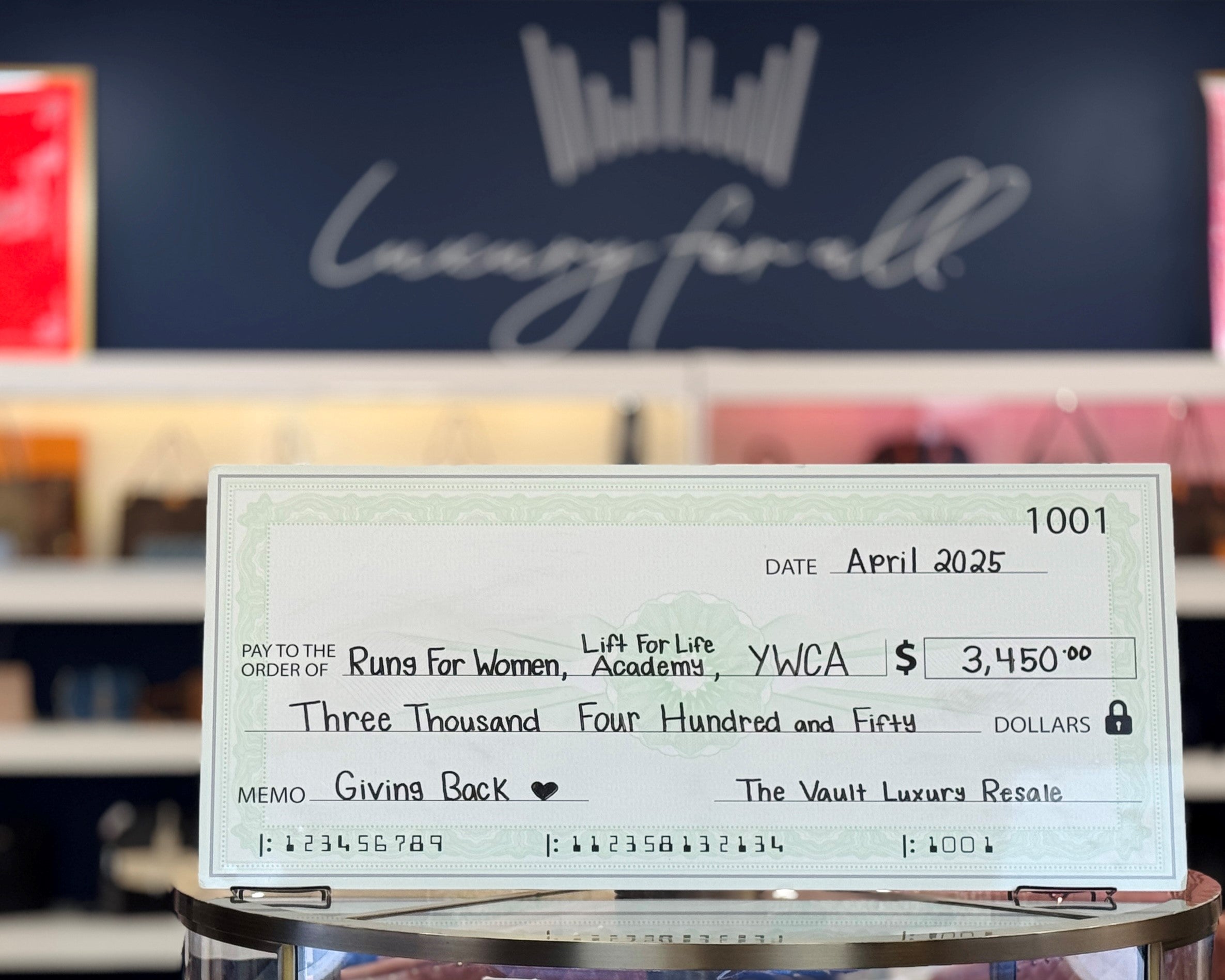 A photo of a large, dry-erase check written out to our donation recipients.