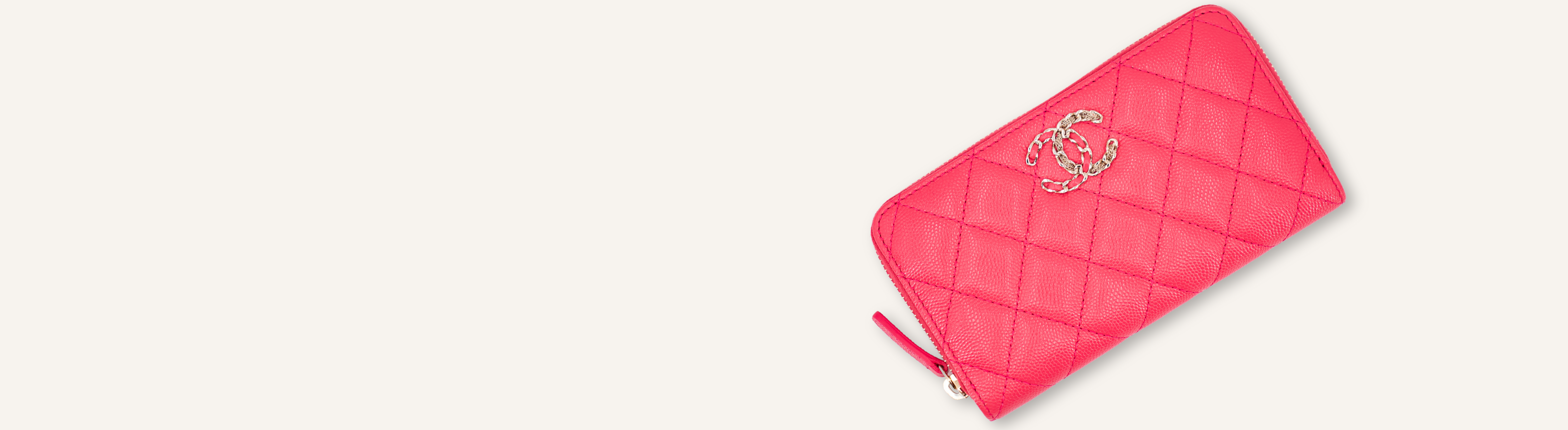 A banner of a pink Chanel wallet on a pale tan background.